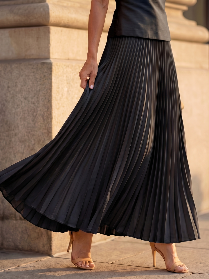 Sophisticated women's pleated maxi skirt set with a stylish structured bodice for a chic look.