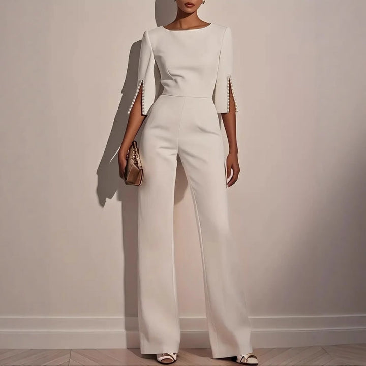 Women's elegant tailored jumpsuit with sophisticated pearl detailing. Ideal for formal events & evening wear.