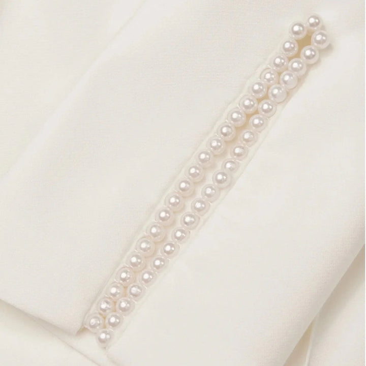 Formal women's jumpsuit, expertly tailored for a sleek silhouette. Features elegant pearl accents on the neckline.
