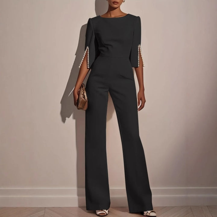 Dressy women's jumpsuit with unique pearl details, offering a smart casual to formal style.