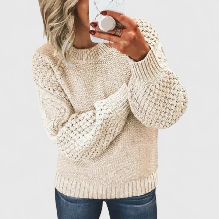 Stylish women's mock neck sweater featuring textured fabric and dramatic puff sleeves for an elegant look.