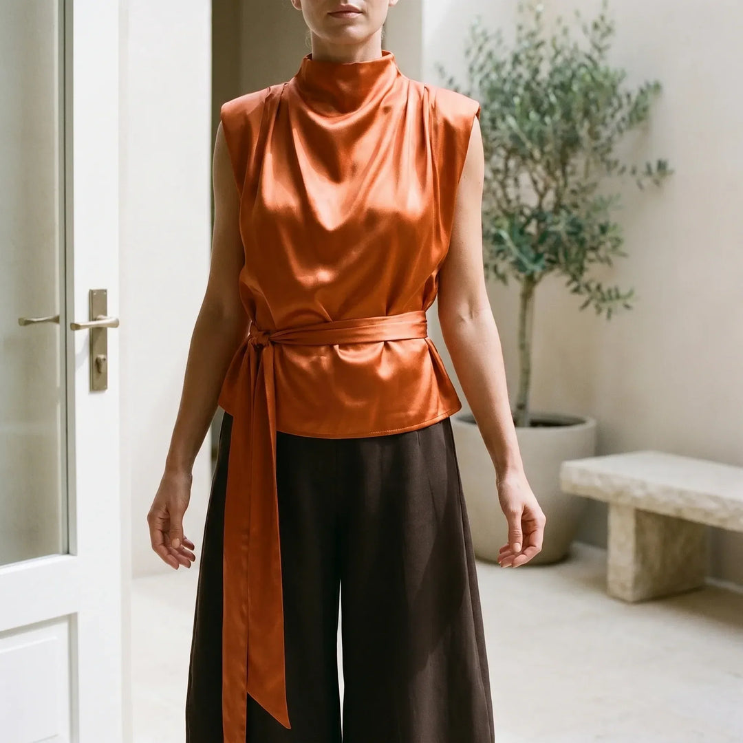 Women's elegant tie-waist sleeveless top, perfect for sophisticated summer fashion.