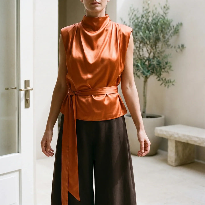 Women's elegant tie-waist sleeveless top, perfect for sophisticated summer fashion.