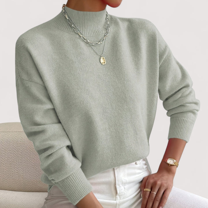 Fashionable women's turtleneck sweater, a cozy knit long-sleeve top, perfect for winter layering style.