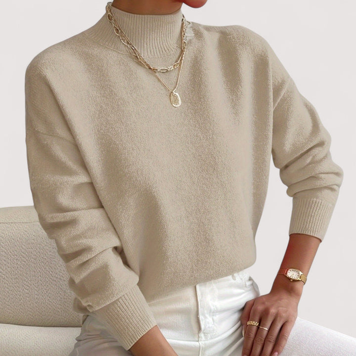 Elegant women's knit turtleneck top, ideal for a sophisticated winter look. Soft, long-sleeve sweater.