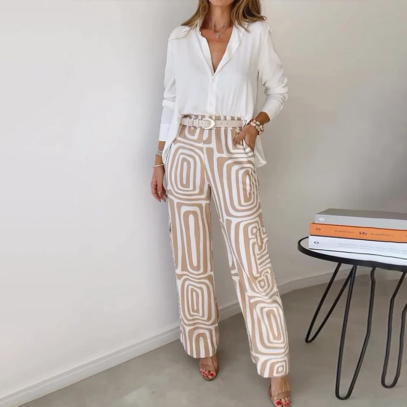 Women's elegant two-piece set featuring a flowing top and stylish patterned trousers. Perfect for sophisticated wear.
