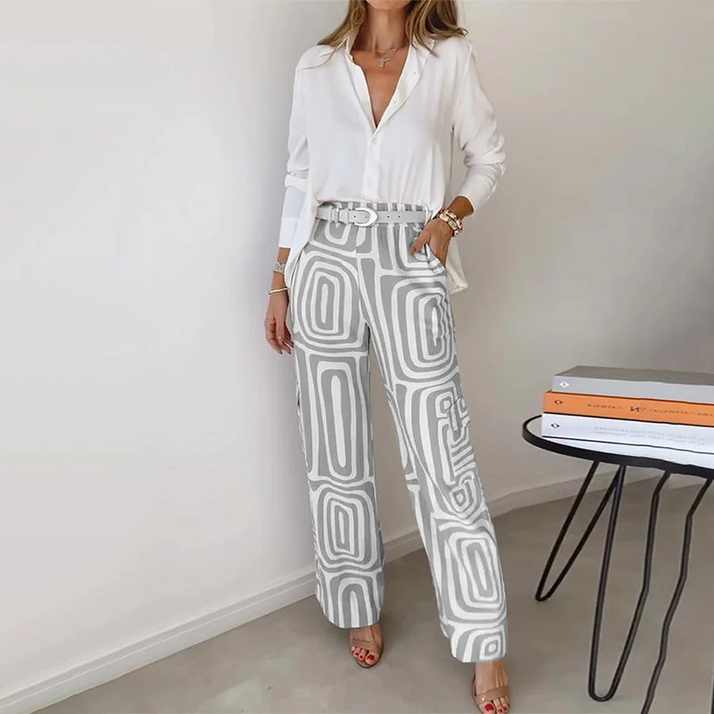 Stylish orange women's two-piece set. Features a flowing top and chic patterned trousers for versatile sophisticated wear.