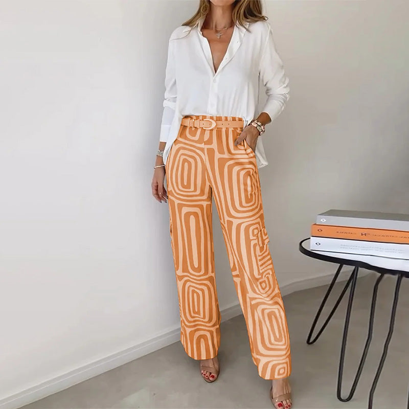 Versatile women's elegant two-piece set with a soft flowing top and fashionable patterned trousers. Casual chic appeal.