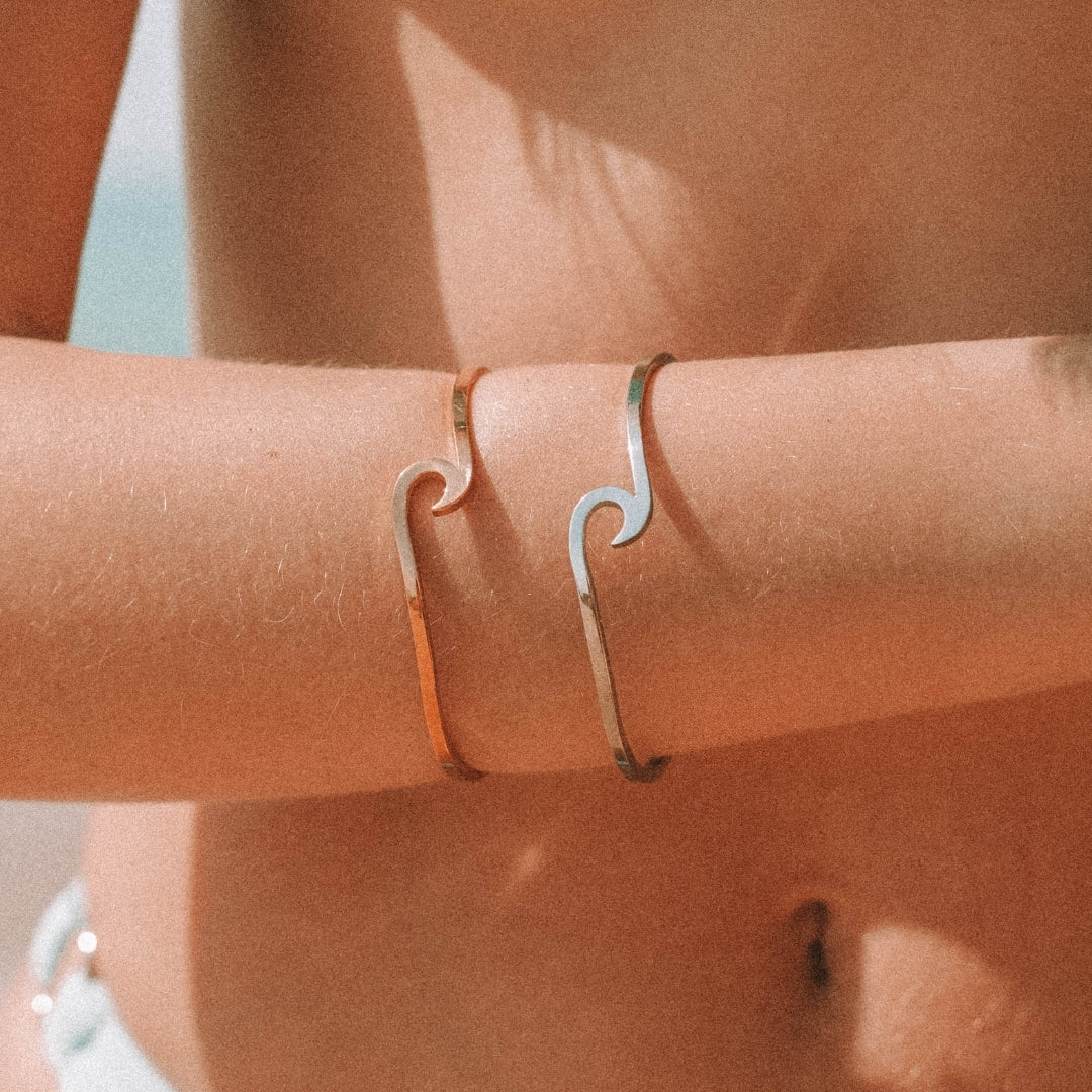 Elegant silver and gold wave bracelet for women. Delicate, adjustable, and ocean-inspired modern jewelry.