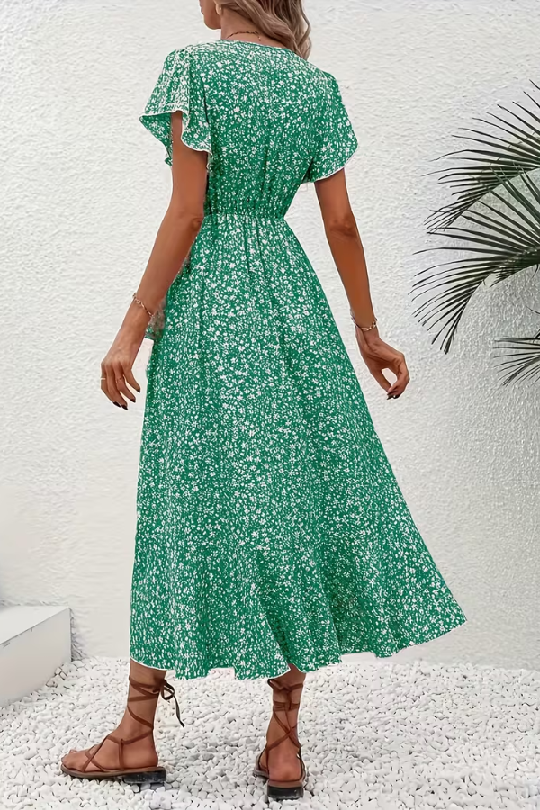 Side profile of a women's V-neck floral dress, showcasing its elegant drape and fit.