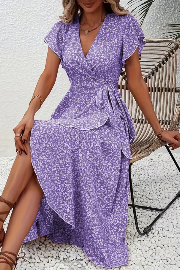 Hanging display of a women's elegant V-neck floral dress, beautiful print and silhouette.