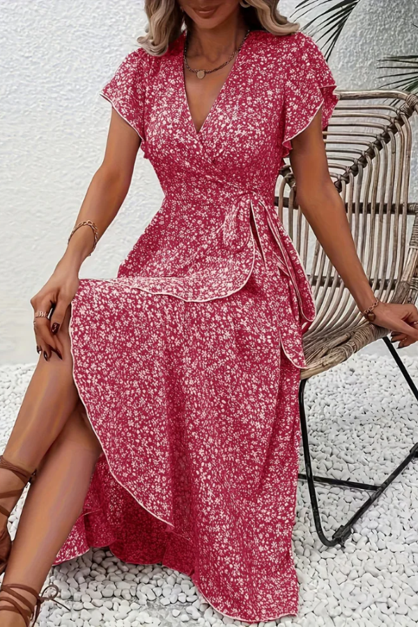 Close-up on the fabric texture of a women's V-neck floral midi dress, soft and elegant.