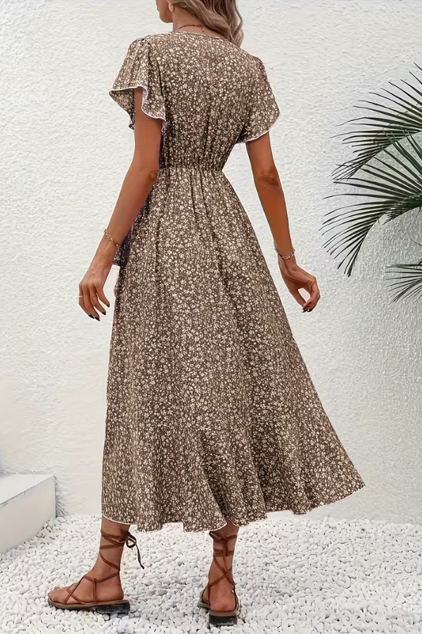 Full shot of a model wearing a women's V-neck floral midi dress, elegant silhouette.