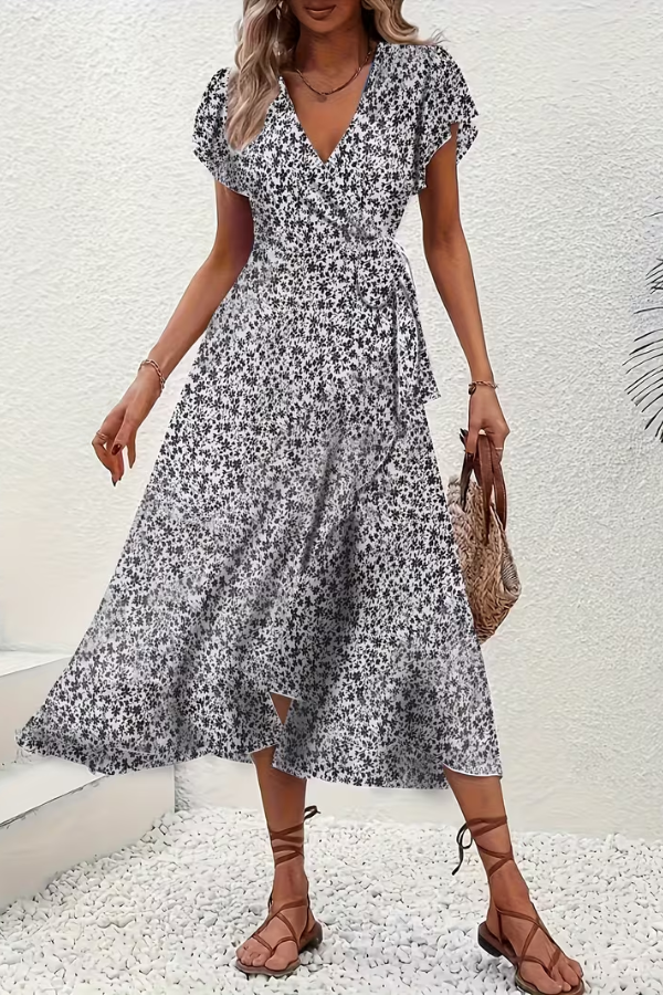 Detail of the flattering V-neckline and short sleeves on an elegant women's floral midi dress.