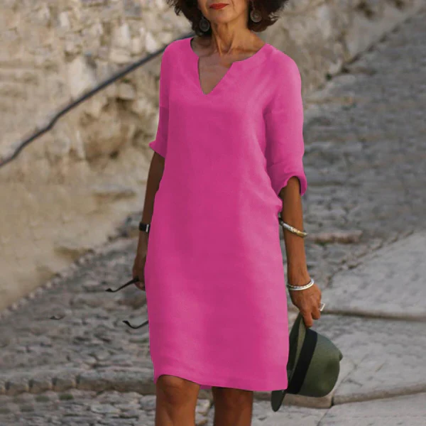Elegant white V-neck women's dress, three-quarter sleeve, loose fit for warm weather comfort.