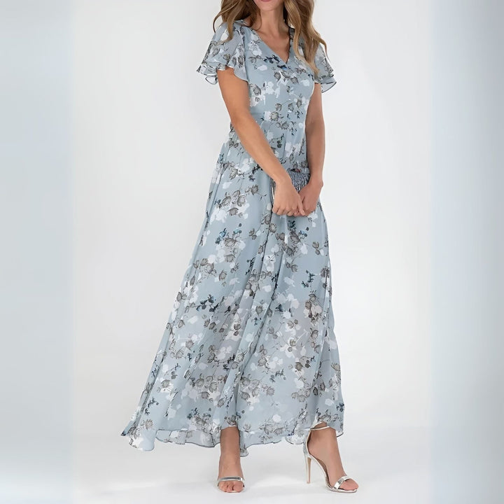 Close-up of women's elegant watercolor floral print maxi dress, showing vibrant artistic print & flowy fabric.
