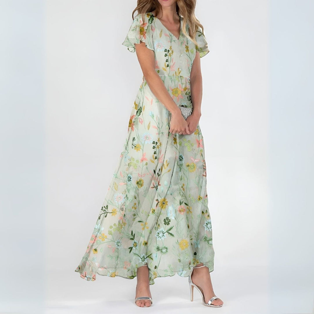 Back view of women's elegant watercolor floral maxi dress, showcasing graceful drape and beautiful summer design.
