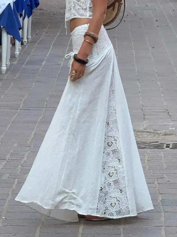 Comfortable women's flowy white maxi skirt with elegant lace panels, ideal for versatile summer outfits.
