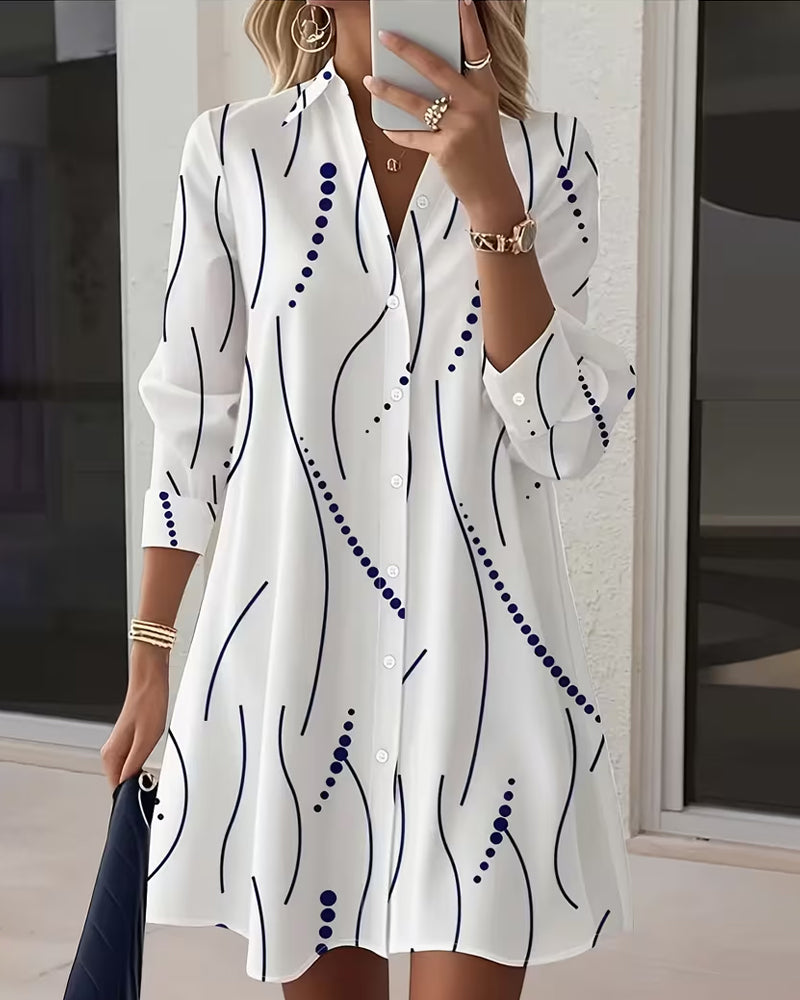Flowing long sleeve women's maxi dress in white with an elegant leafy print. Comfortable for all-day wear.