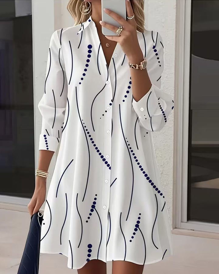 Flowing long sleeve women's maxi dress in white with an elegant leafy print. Comfortable for all-day wear.
