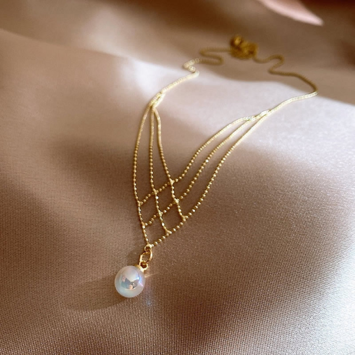Women's elegant woven pearl necklace, a timeless fashion accessory for sophisticated style.