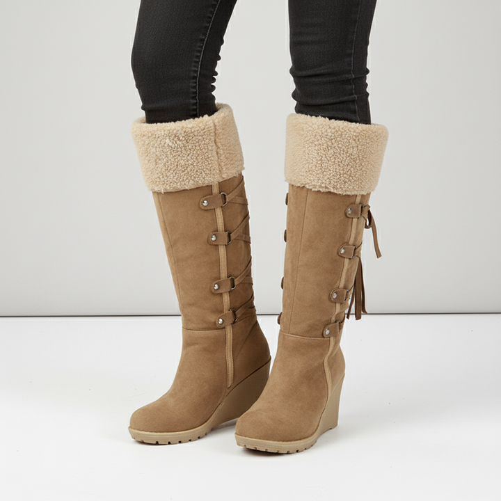 Model wearing 'Elena' women's winter boots, highlighting the knee-high style and wedge heel.