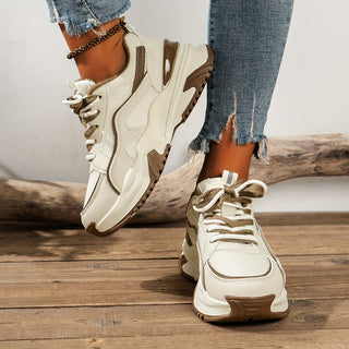 Trendy women's pink platform sneakers with a thick wedge sole, perfect for an elevated sporty chic look.