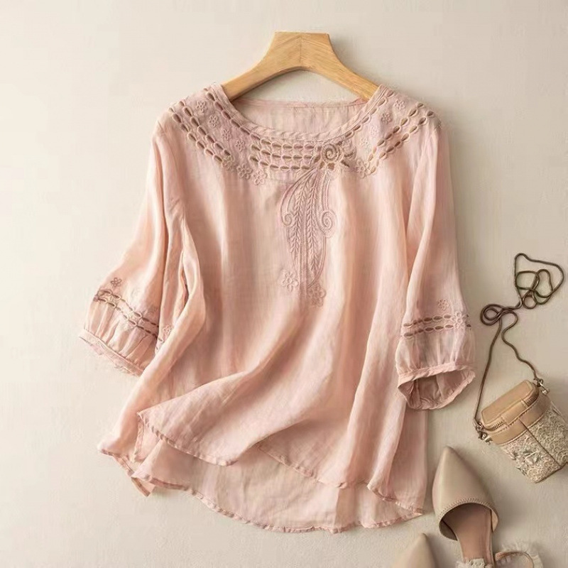 Close-up of embroidered detail on a women's flowy blouse, perfect for casual elegant spring & summer wear.
