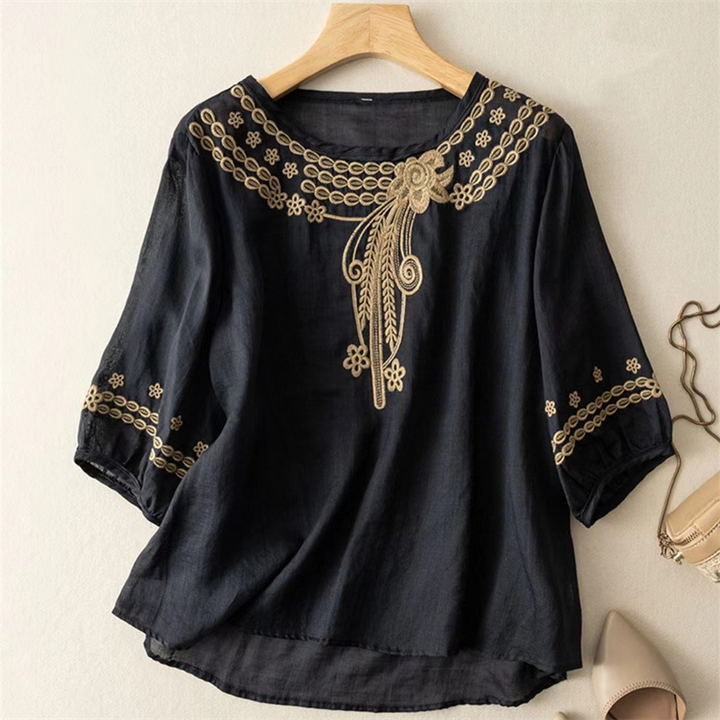 Full shot of women wearing an elegant, comfortable, long-sleeve embroidered flowy blouse. Ideal for everyday style.