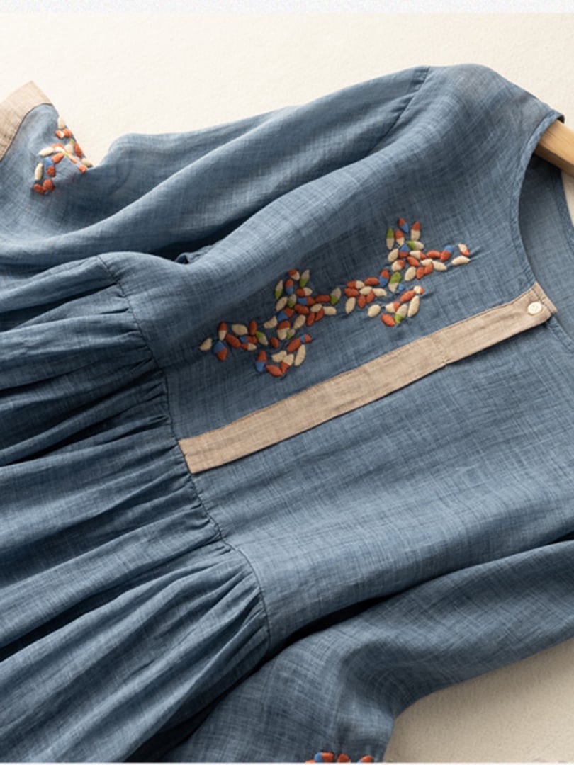 Model wearing a women's embroidered loose fit flared dress. Comfortable, casual, mid-sleeve summer style.