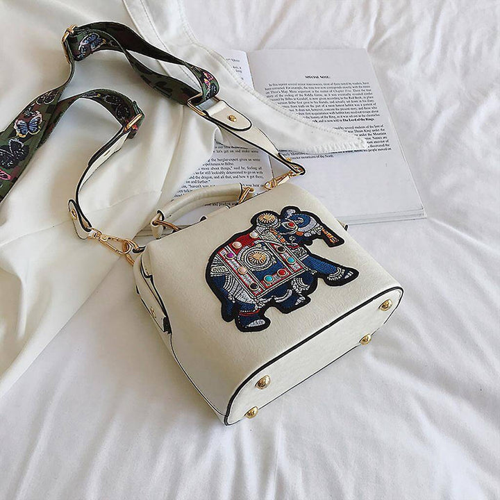 Side view of the embroidered mandala shoulder bag, showcasing its slim profile and lightweight design