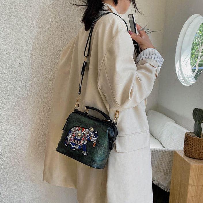 Close-up of embroidered mandala pattern on a women's bohemian shoulder bag, vibrant threads