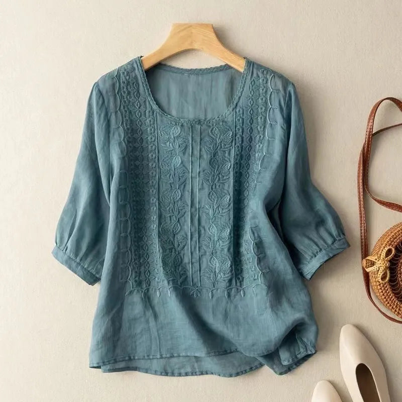 Stylish women's floral embroidered blouse with comfortable puff sleeves and a round neck.