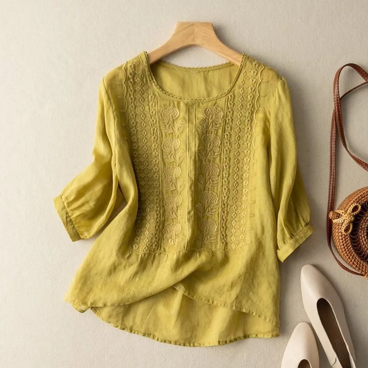 Flowy women's blouse, elegant embroidered floral details, puff sleeves, perfect for casual tops.