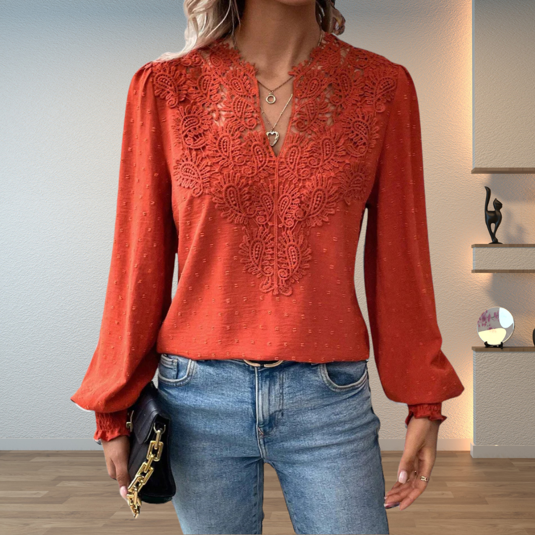 Women's embroidered V-neck long sleeve blouse with delicate floral design.