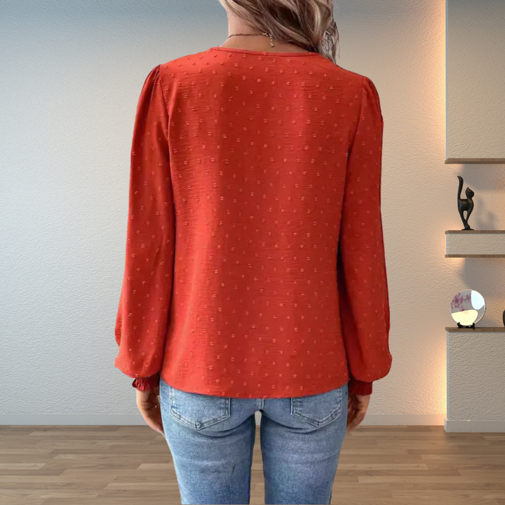 Elegant women's V-neck blouse, long puff sleeves, intricate floral embroidery.