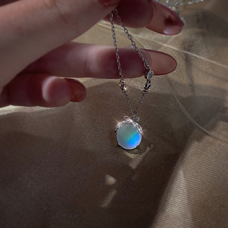 Charming silver firefly pendant necklace for women, featuring a glowing moonstone gem.