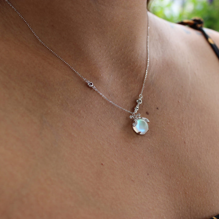 Elegant women's delicate silver necklace with enchanting firefly and iridescent moonstone.