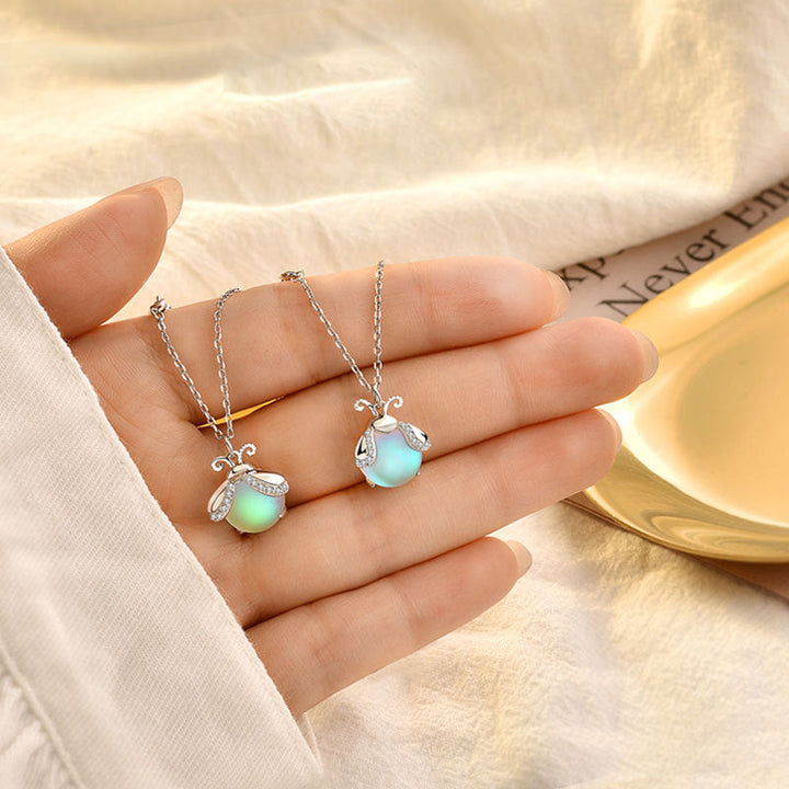 Enchanting women's firefly necklace with a luminous moonstone, elegant silver pendant jewelry.