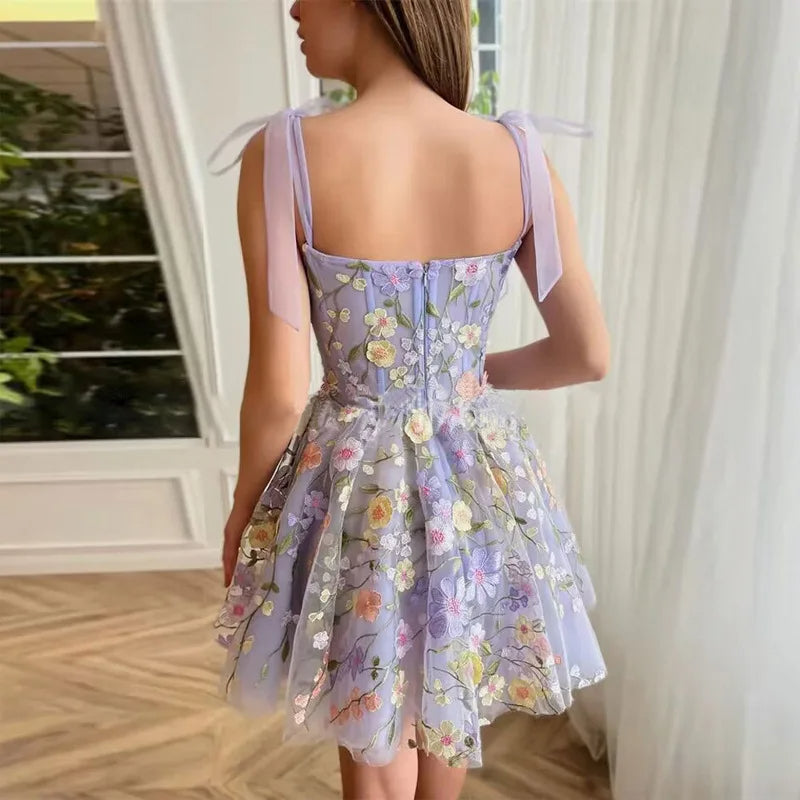 Women's formal appliqué dress. Rose-colored tulle, flared skirt & floral designs for elegant parties.