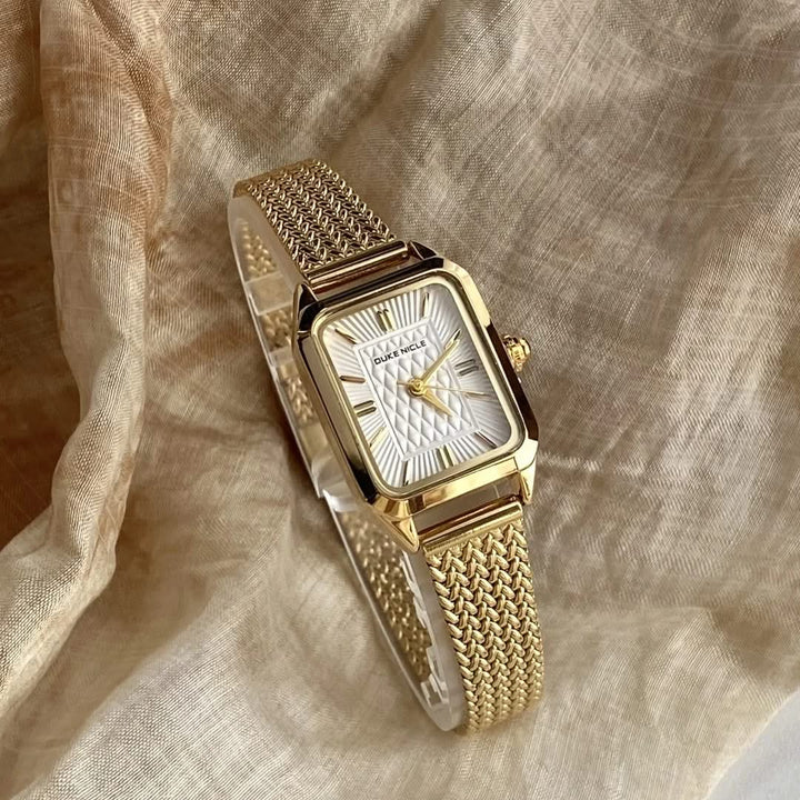 Gold-tone Estella women's elegant stainless steel wristwatch, chic fashion accessory with adjustable strap.