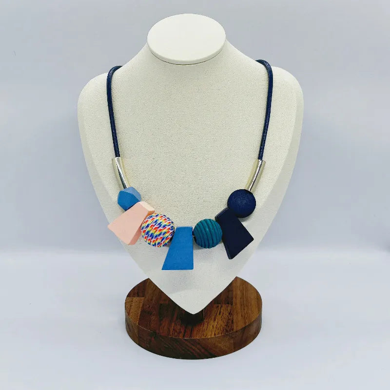 Close-up of a women's ethnic geometric wooden bead necklace. Handcrafted natural wood accessory.