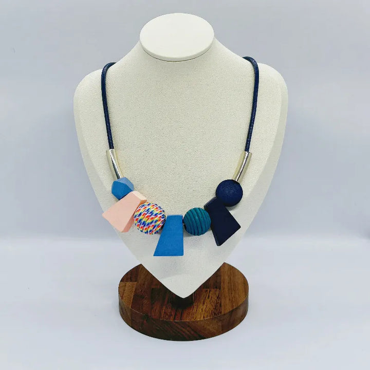 Close-up of a women's ethnic geometric wooden bead necklace. Handcrafted natural wood accessory.