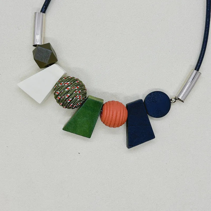 Women's boho ethnic geometric wooden bead necklace. Unique handmade natural wood jewelry for fashion.