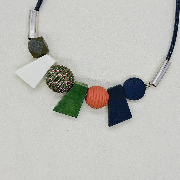 Women's boho ethnic geometric wooden bead necklace. Unique handmade natural wood jewelry for fashion.