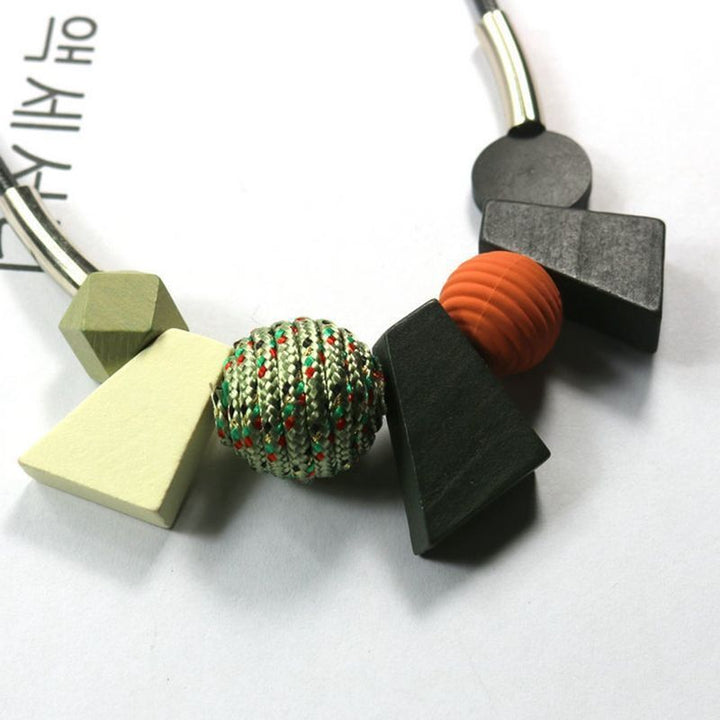 Statement women's ethnic geometric wooden bead necklace. Handmade natural wood jewelry for boho fashion.