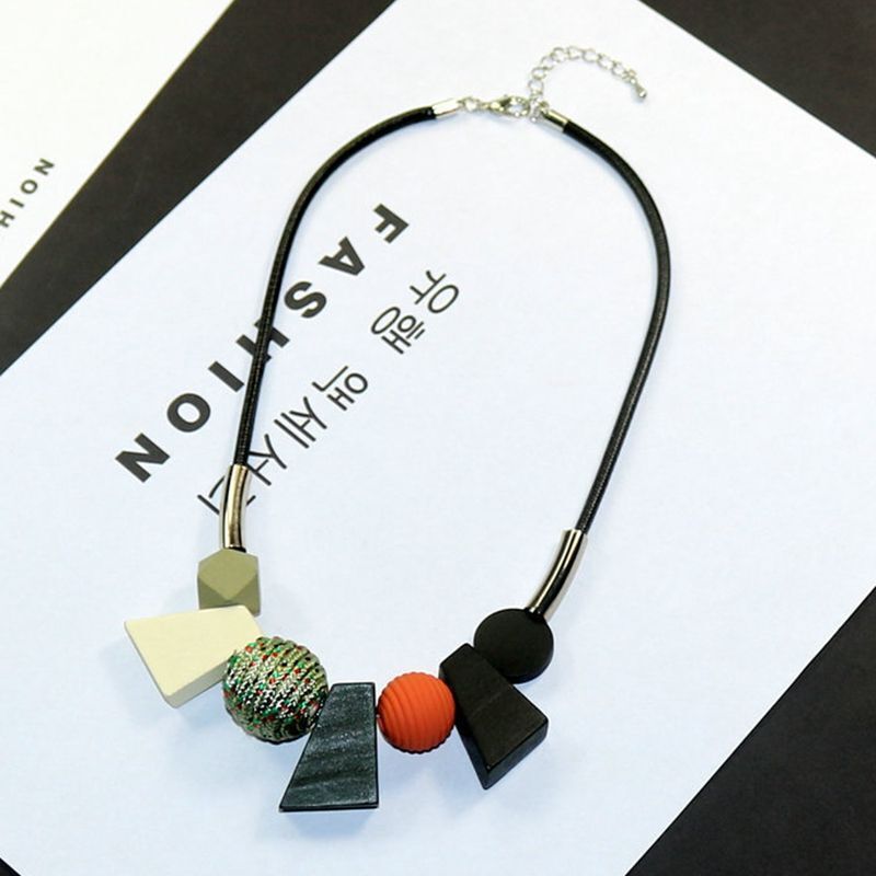 Women's ethnic wooden bead necklace with geometric design. Handmade natural wood accessory, boho chic.