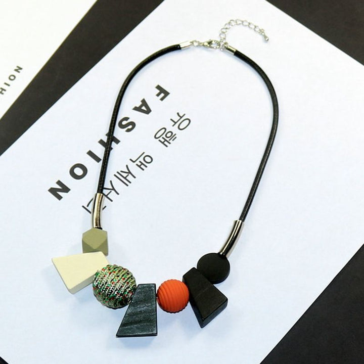 Women's ethnic wooden bead necklace with geometric design. Handmade natural wood accessory, boho chic.