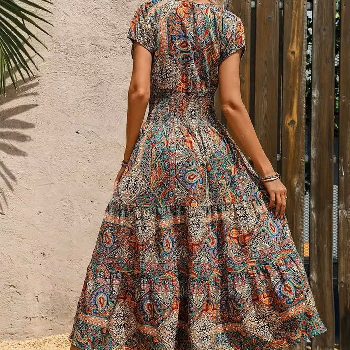 Flowy women's summer maxi dress with intricate ethnic print and elegant V-neck. Casual vacation style.