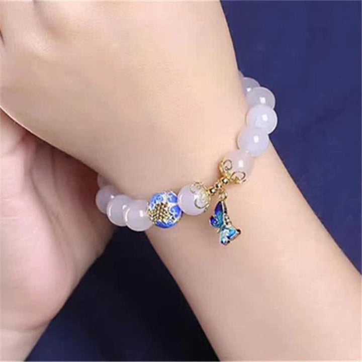 Close-up of women's white agate butterfly bracelet, a spiritual gemstone jewelry piece